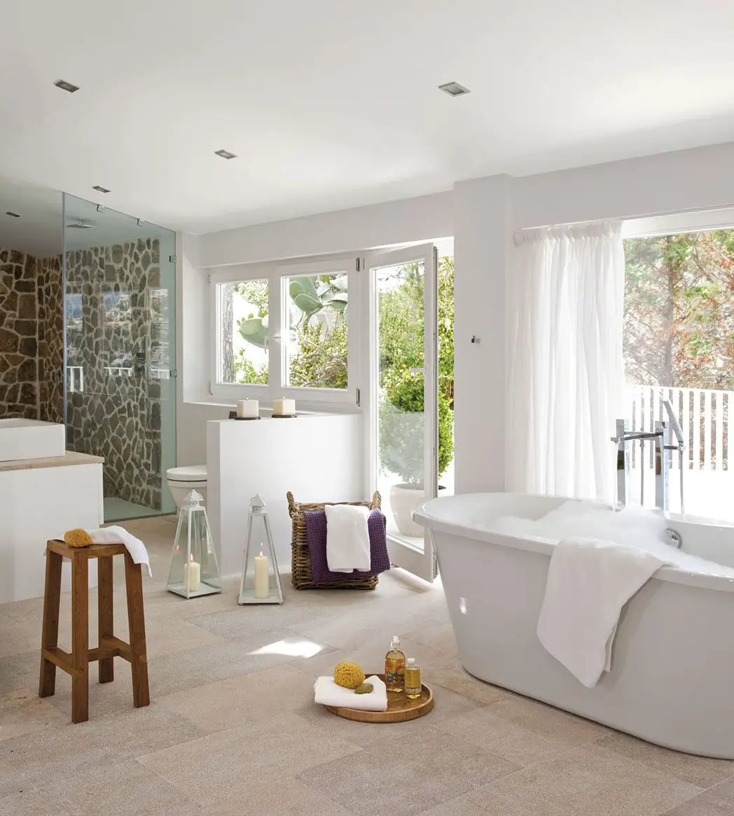 A house with a white bathroom featuring a bathtub and sink.