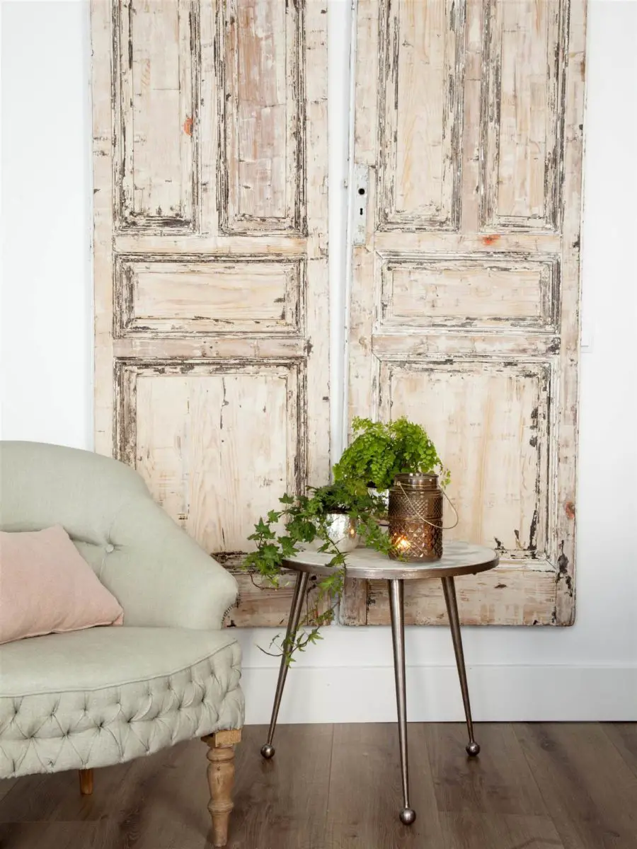 A pair of old wooden doors with woodworm.