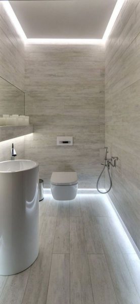 A modern bathroom with a white toilet and sink designed for small bathrooms.