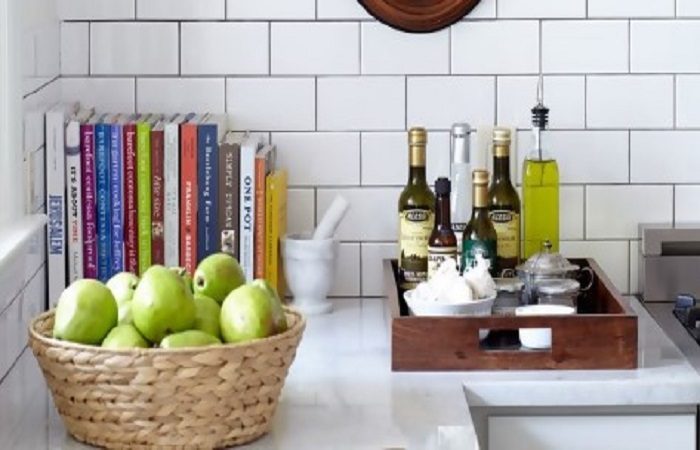 A kitchen with a basket of apples.