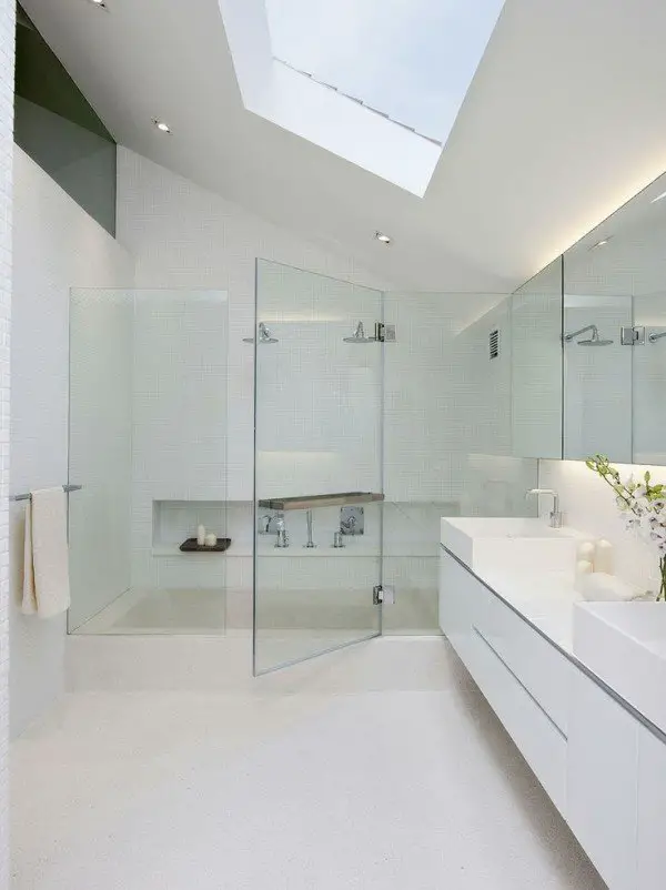 A minimalist bathroom with a skylight.