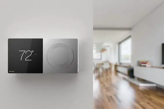 A smart thermostat is mounted on the wall of a living room in a smart home.
