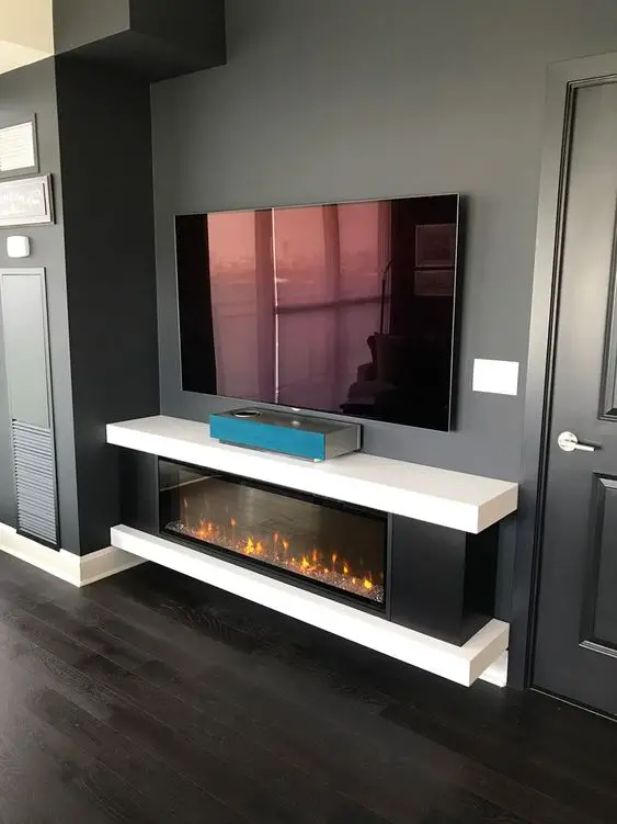 Modern living room with mounted TV and electric fireplace.
