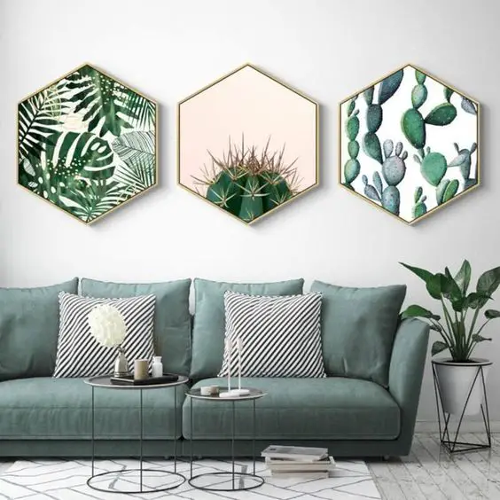 Three green cactus prints hanging above a couch in an inspirational living room.