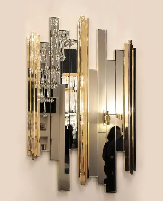 A stylish gold and silver striped mirror for wall decoration.