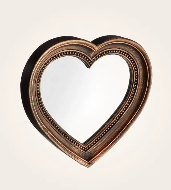 A heart-shaped mirror with creative ideas on a white background.