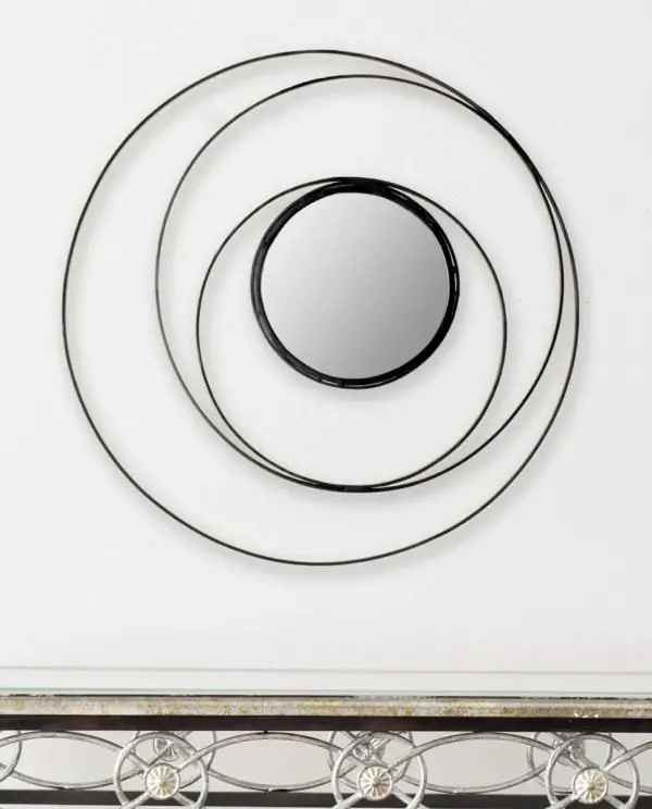 A circular black mirror design.