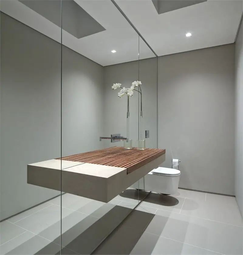 A modern bathroom with a wooden sink and mirror suitable for small bathrooms.