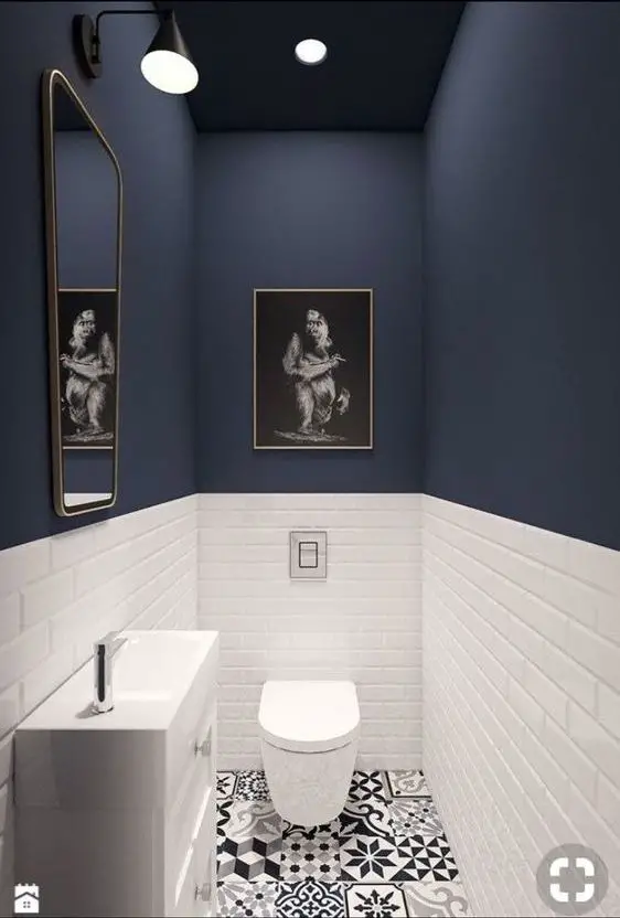 A small bathroom with blue walls.