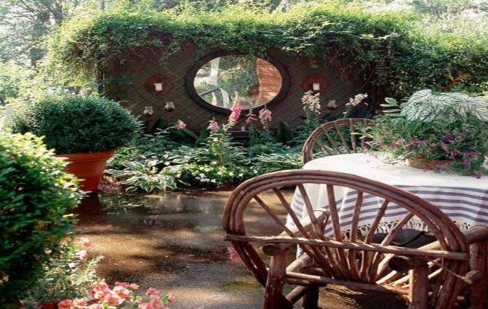 A garden with a table and chairs.