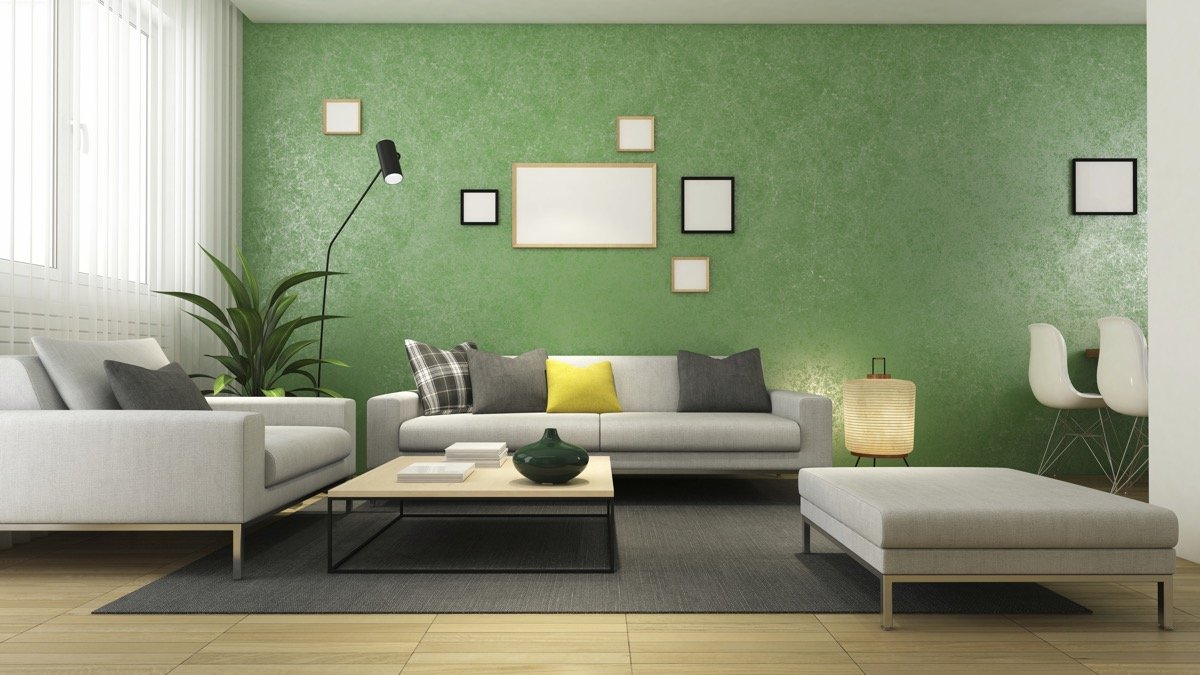 An inspirational living room with green walls and white furniture.