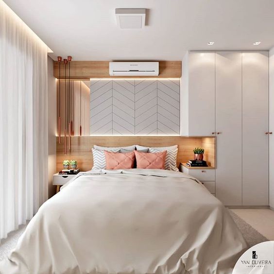 A luxurious bedroom with white walls and a white bed.