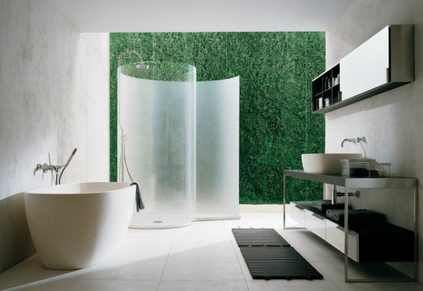 A green-themed bathroom with grass walls showcasing unique shower room designs.