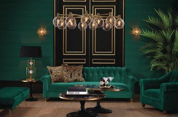 A living room with green velvet furniture and gold accents that is stylish and inspirational.