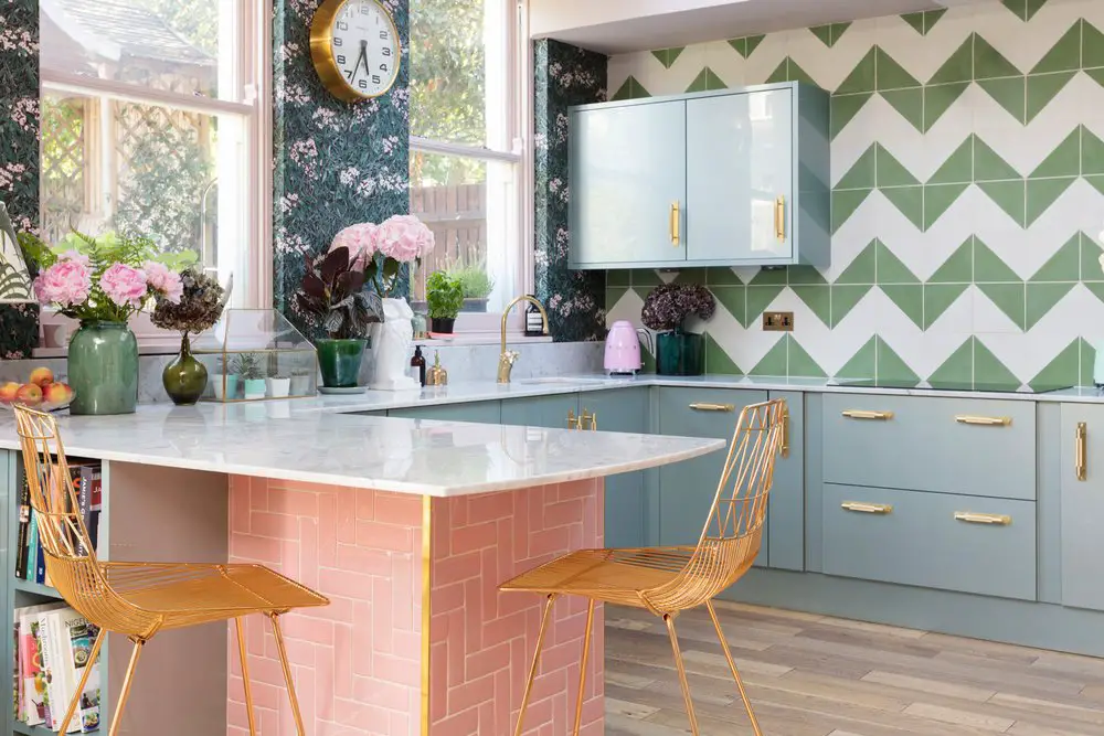 A pink kitchen with chevron tiles.