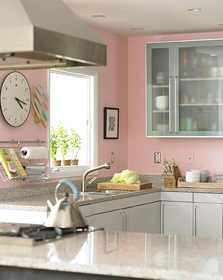 A kitchen adorned with pink walls.