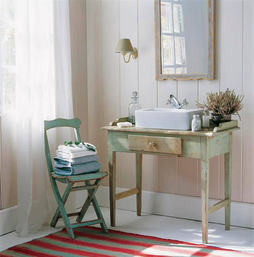 Renovate: A small bathroom with a sink and a chair for renovation.