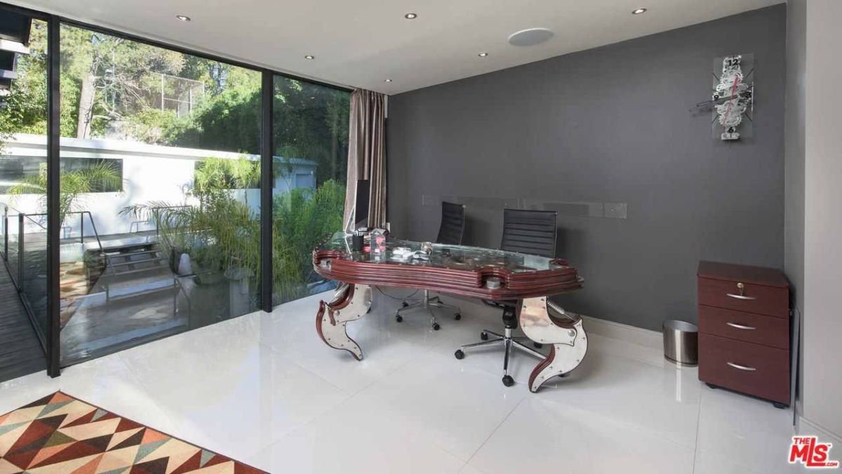 An inspirational home office with glass doors and a desk.
