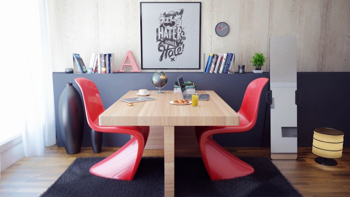 A modern home office with red chairs and a wooden table.