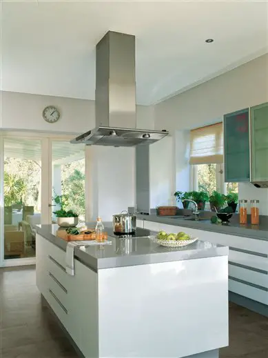 A modern kitchen design with a white island and stainless steel appliances.