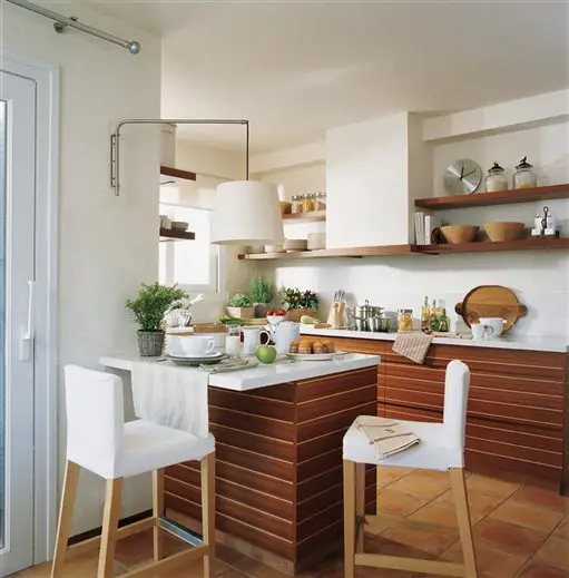 A small kitchen with wooden cabinets and stools, designed for functionality and style.