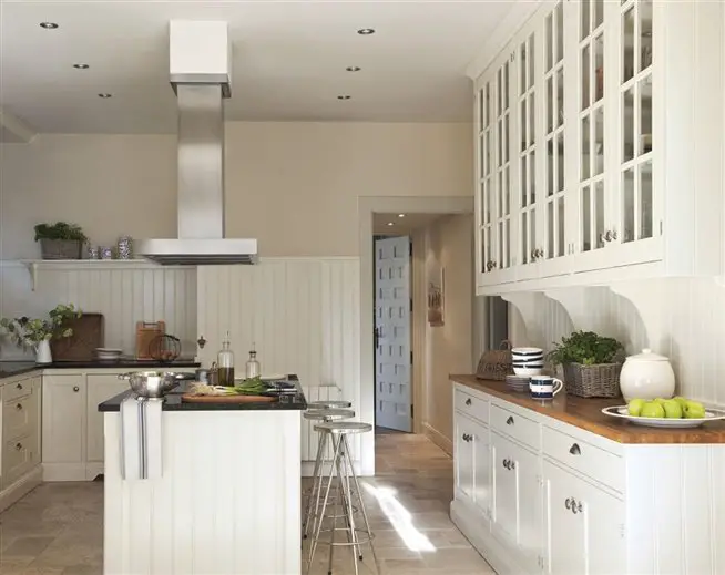 A kitchen design featuring a white ambiance and a wooden center island.