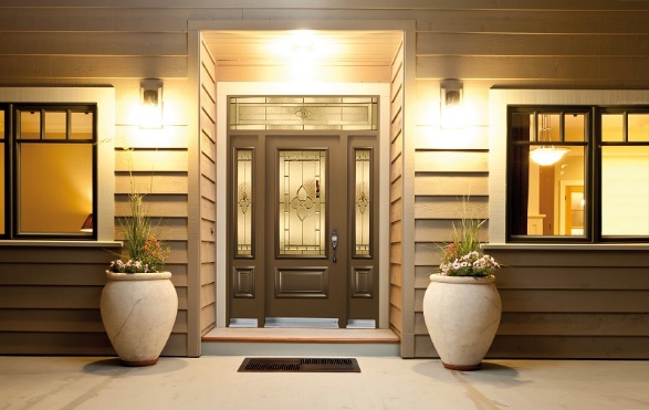 The front door of a home is lit up at night as part of a home project involving lighting.