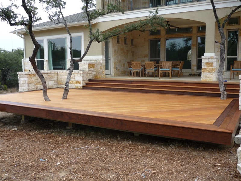A wooden deck with a tree in the background, perfect for home projects.