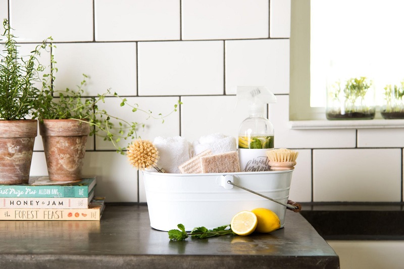 A white bucket with plants on a counter providing remodeling ideas.