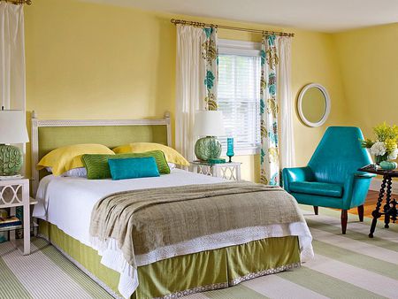 A bedroom with yellow walls and green accents, showcasing different paint colors.
