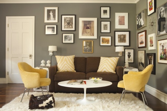 A room with yellow chairs and pictures on the wall.