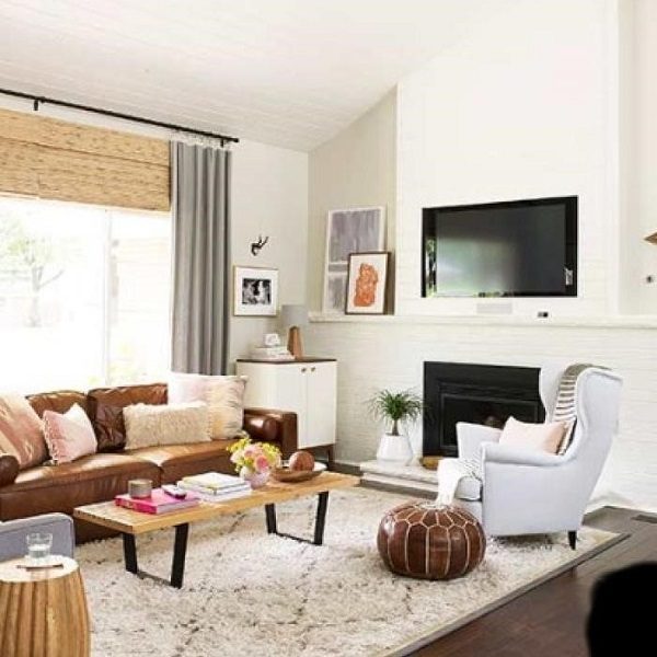 A living room with brown leather furniture.