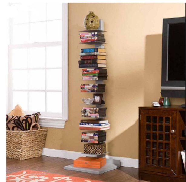 A stack of books on a tropical stand next to a TV.