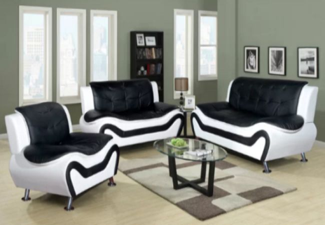A black leather living room set with a coffee table.