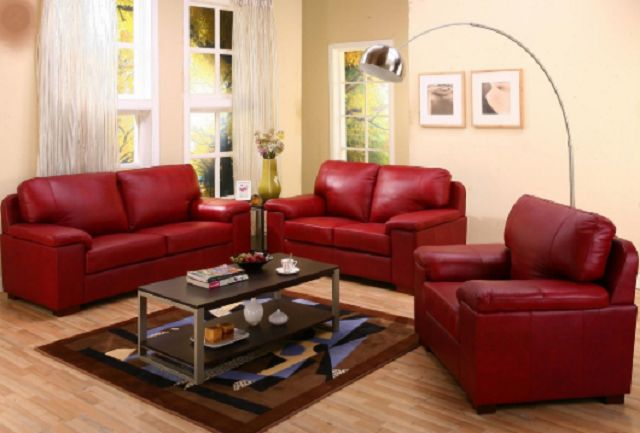 A living room with red leather furniture.