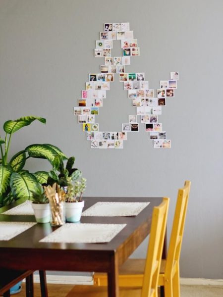 A room with a table, chairs, and photos on the wall.