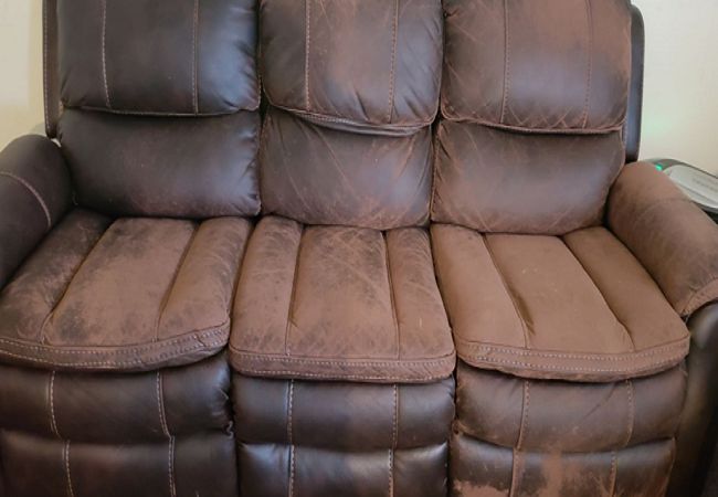 A leather recliner is sitting in a room.