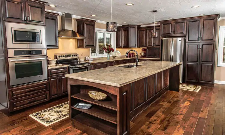 A standard kitchen with dark wood cabinets and a center island.