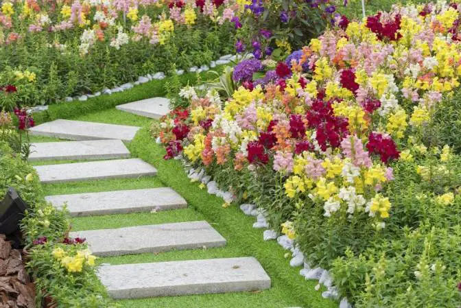 A DIY garden with colorful flowers and stepping stones.