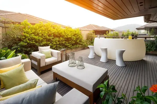 A wooden deck with terrace furniture.