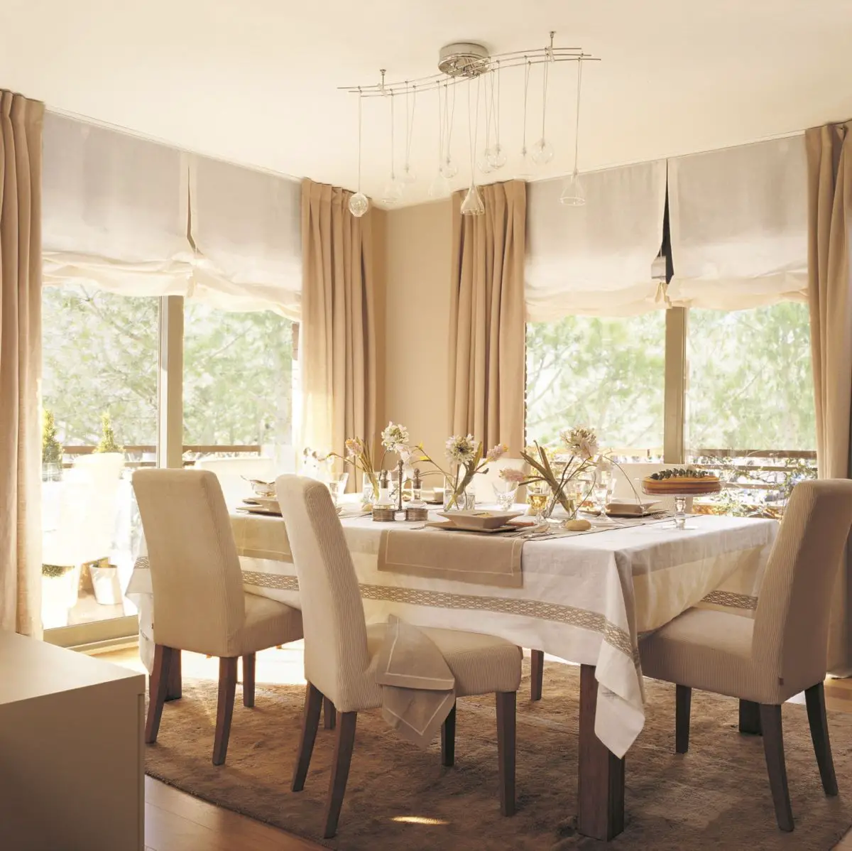 A dining room with beige curtains.