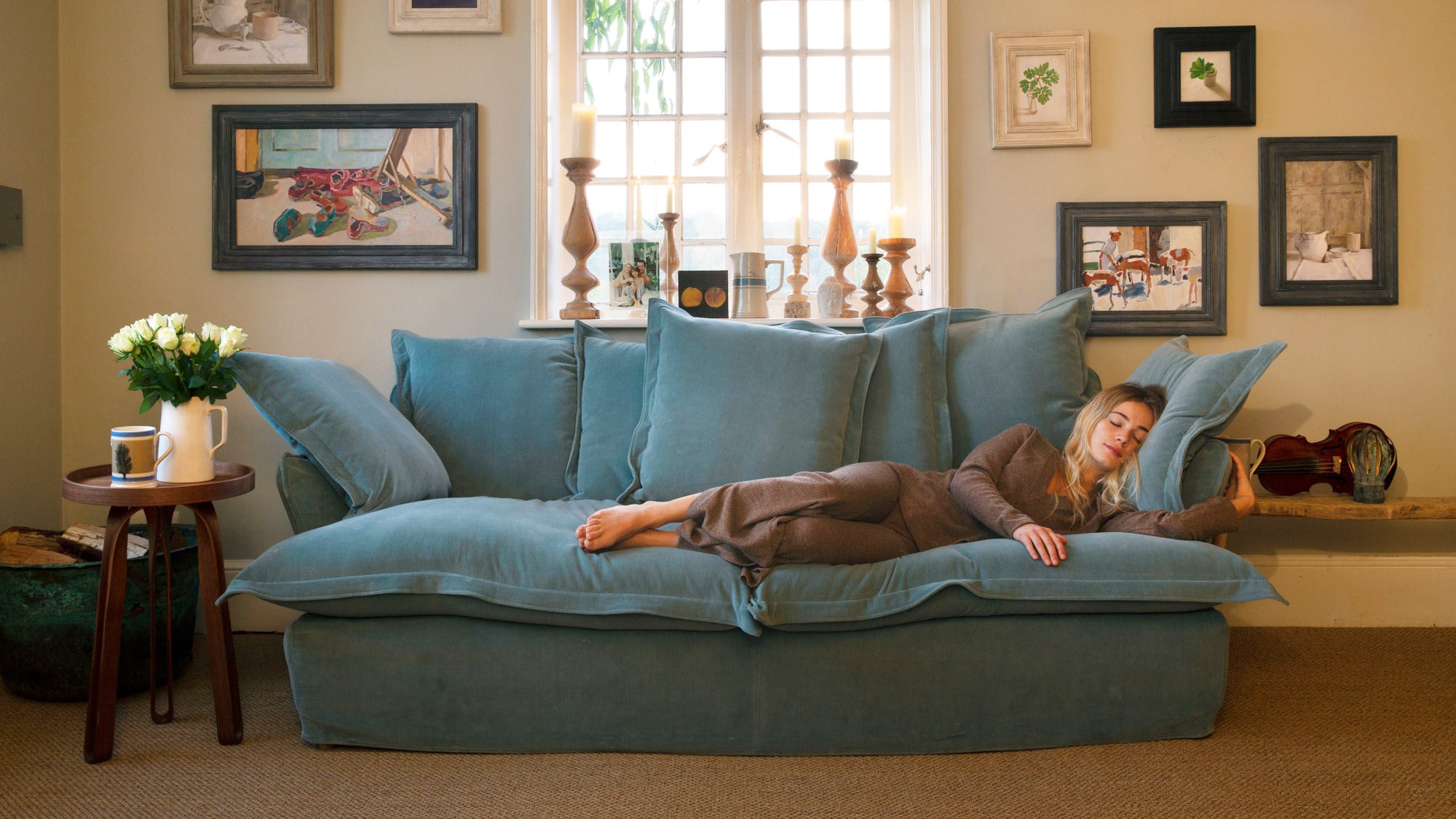 A woman lounging on a natural couch.