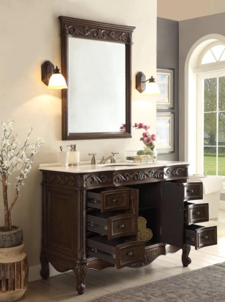 An ornate piece of furniture featuring a bathroom vanity with a mirror.