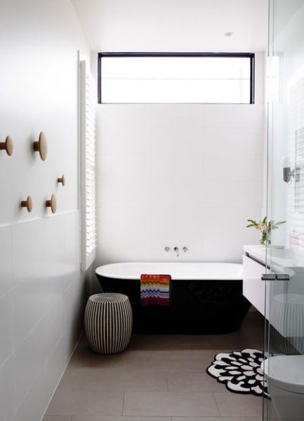A monochromatic bathroom featuring a bathtub.