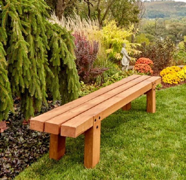 A wooden bench serves as a garden decoration.