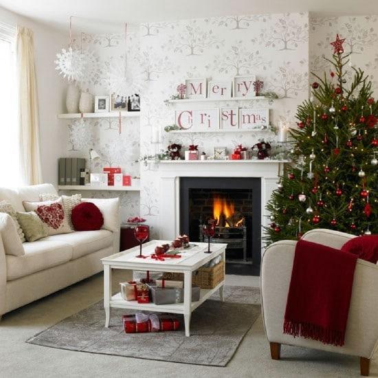 A Christmas-themed living room adorned with festive red and white decorations.