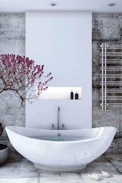 A bathroom furnished with a white bathtub and a tree.