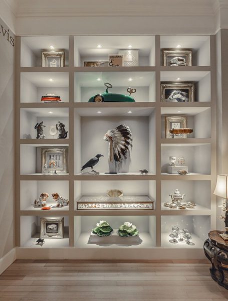 A white shelf displaying a collection of items.