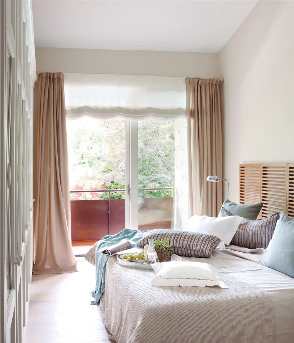 A bedroom with beige curtains.