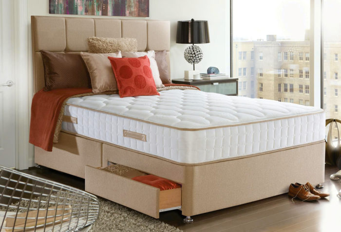 A bedroom with an upgraded mattress.
